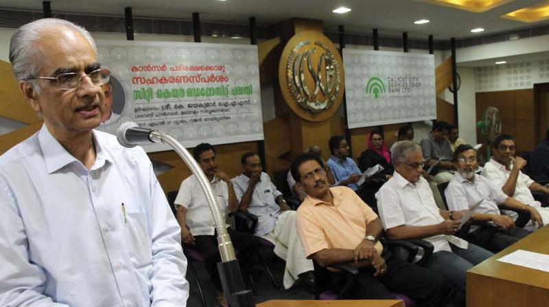 Malayalam University VC K. Jayakumar announces interest-free cancer treatment loan scheme at Chalappuram branch of Calicut City Service Co-Op bank on Thursday.