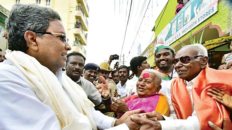 Chief Minister Siddaramaiah with people of Ramagondanahalli in Bengaluru where he launched Mane Manege Congress campaign  on Saturday  	(Photo:DC)