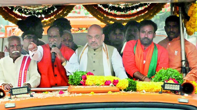 BJP national president Amit shah along with partys Telangana state president K. Laxman, leaders Bandaru Dattreya and Kishan Reddy participate in a the road show at Ramnagar on Wednesday.  (Deepak)