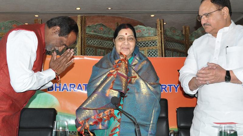 Union minister Sushma Swaraj addresses the media as Union minister J.P. Nadda and state BJP president Dr K. Laxman look on.  (Gandhi)