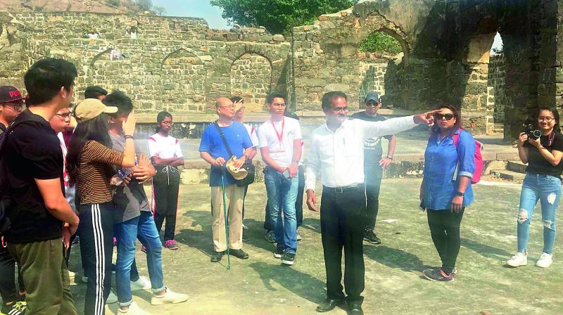 Historian E. Sivanagi Reddy narrates the history of the Kondapalli fort to students from Singapore on Wednesday. 	 (Deccan chronicle)