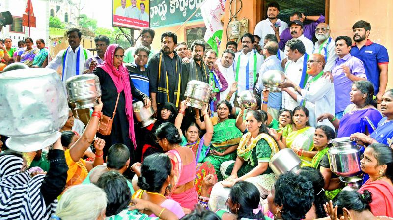 Political leaders join residents of Arilova Colony in their protest against acute water shortage in the area, in Visakhapatnam on Wednesday. 	 (DC)