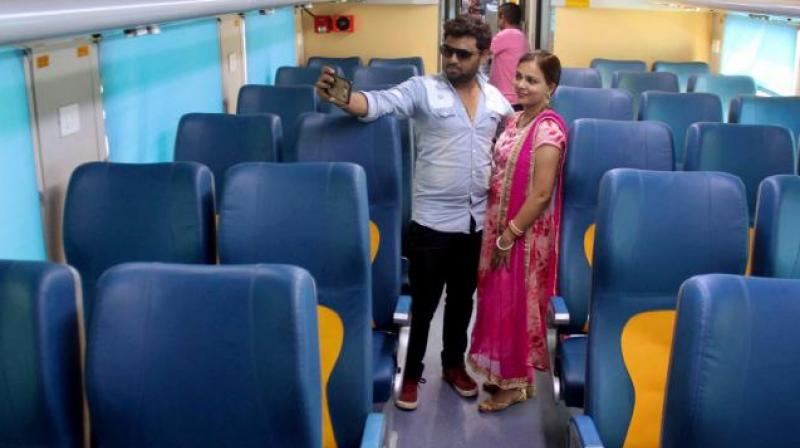 A couple snaps selfie inside a coach of Tejas Express before it was flagged off at CS Terminus in Mumbai. (Photo: AP)