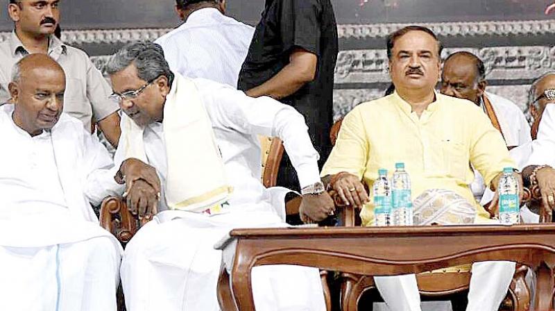 CM Siddaramaiah in conversation with JD(S) supremo H.D. Deve Gowda while state BJP chief B.S. Yeddyurappa looks at them at a convention of Balijas in Bengaluru on Sunday. Union Minister H.N. Ananth Kumar is seen. (Photo: DC)