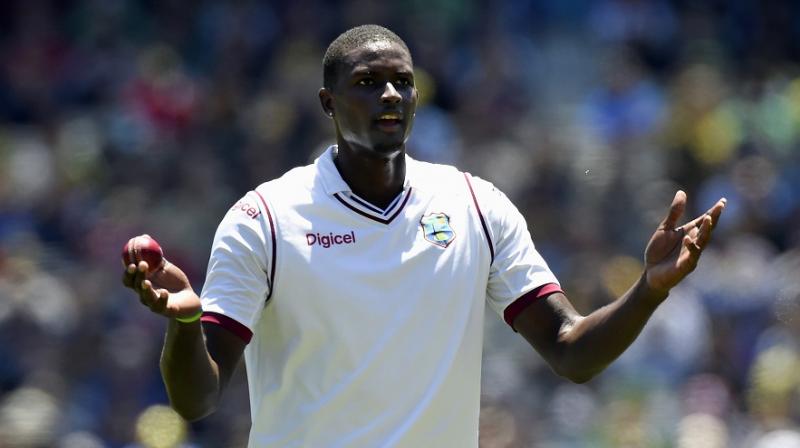 Jason Holder has been suspended for one Test and fined 60 per cent of his match fee, while his players have been fined 30 per cent of their match fees. (Photo: AP)