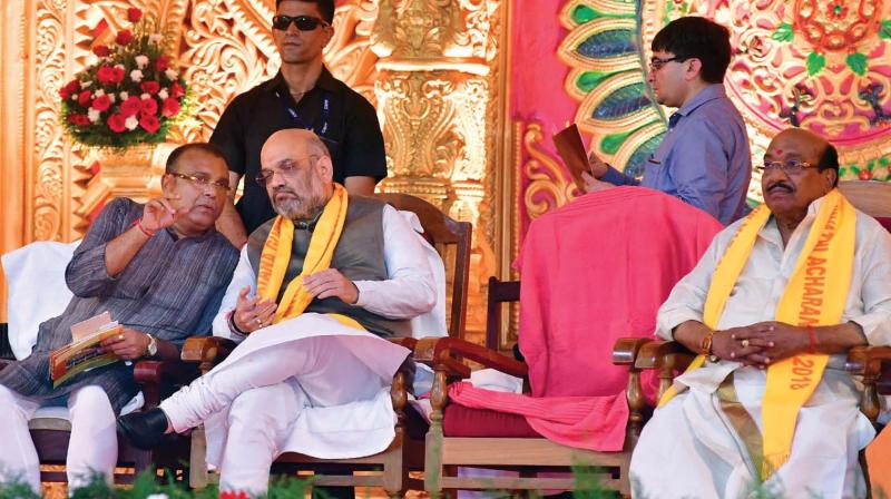 BJP national president Amit Shah having a chat with BDJS national president Tushar Vellapally at Sivagiri Mutt when the former came to inaugurate the 90th samadhi of Sreenarayana Guru at Sivagiri Mutt. Also seen is SNDP Yogam general secretary Vellapally Natesan.	DC