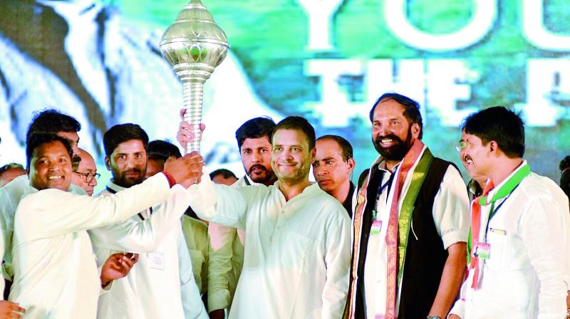 Congress vice-president Rahul Gandhi is holds a mace during the Telangana Praja Garjana at Sangareddy town on Thursday as TPCC president Uttam Kumar and others look on. (Photo: S. SURENDER REDDY)