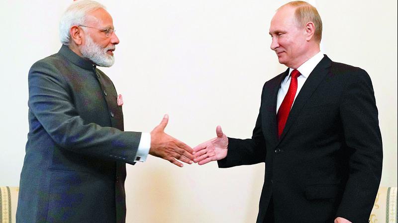 Russian President Vladimir Putin shakes hands with Prime Minister Narendra Modi prior to their talks at the International Economic Forum in St. Petersburg, Russia, on Thursday. (Photo: PTI)