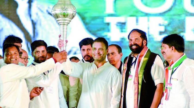 Congress vice-president Rahul Gandhi is holds a mace during the Telangana Praja Garjana at Sangareddy town on Thursday as TPCC president Uttam Kumar and others look on. (Photo: S. SURENDER REDDY)