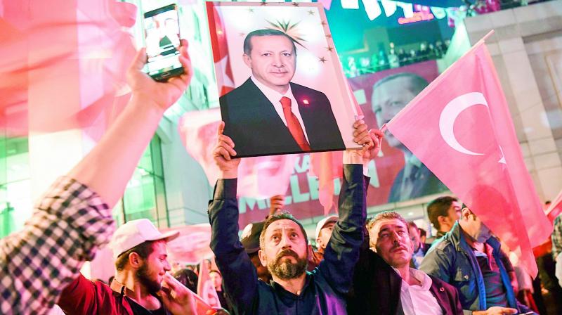 A supporter of the â€œyesâ€camp brandishes a picture of Turkish president Recep Tayyip Erdogan during a rally in Istanbul after the results. (Photo: AFP)