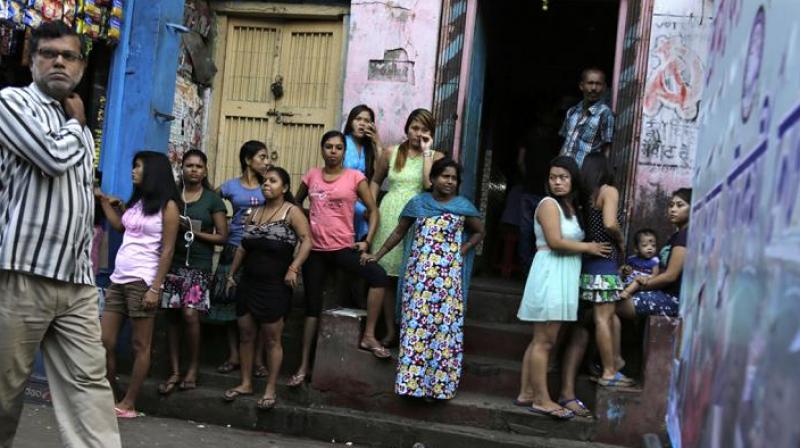 Women stand outside Kolkatas biggest red-light zone, Sonagachhi. (Photo: AP)