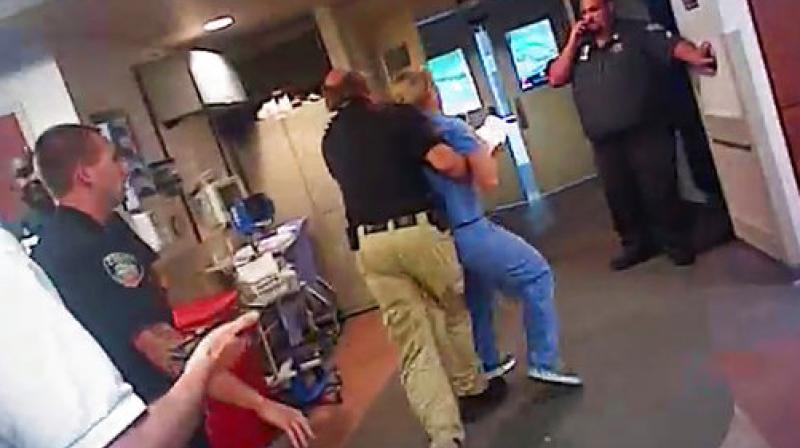 In this July 26, 2017, frame grab from video taken from a police body camera and provided by attorney Karra Porter, nurse Alex Wubbels is arrested by a Salt Lake City police officer at University Hospital in Salt Lake City. (Photo: AP)