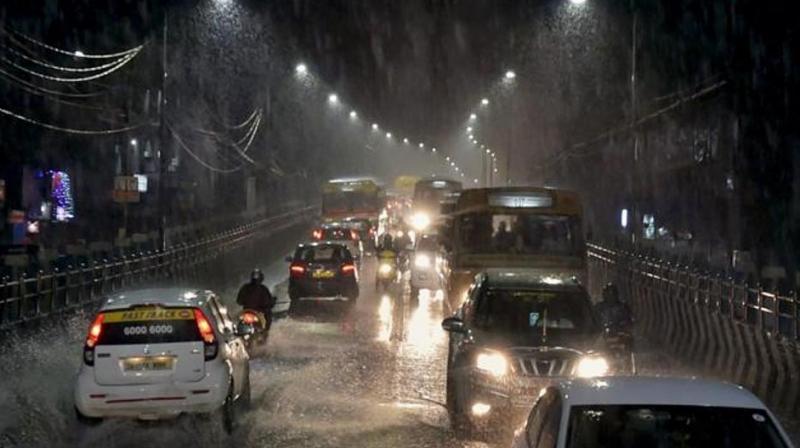 Vehicles move through a waterlogged road as heavy rains lash Chennai. (Photo: PTI)
