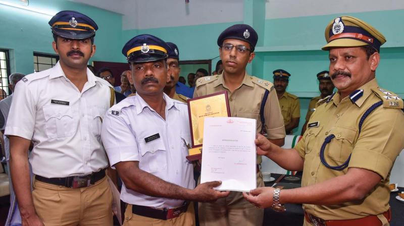 Bijukumar and Sharth Chandran of City traffic police station being given citation by the city police commissioner S Surendran on Saturday for catching a chain snatcher who snatched the gold chain of elderly women within two hours of the incident.