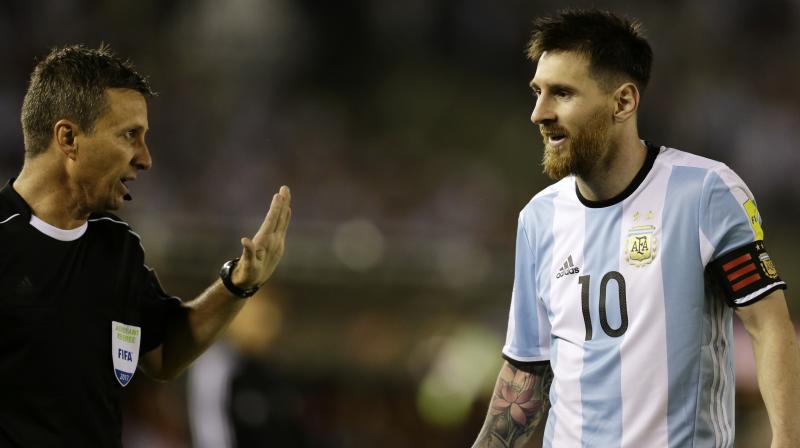 Argentina captain Lionel Messi (left) argues with first assistant referee Emerson Augusto de Carvalho at the end of their 2018 FIFA World Cup South American qualifier match against Chile at the Monumental Stadium in Buenos Aires on last Thursday (Photo: AP)