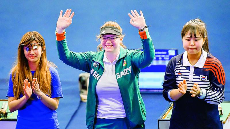 Gold medallist Veronika Major (centre) of Hungary, silver medallist Wu Chia Ying of Taipei (left) and bronze medalist Kim Bomi of Korea celebrate on the podium after the womens 10m air pistol event at the ISSF World Cup Rifle/Pistol at Dr Karni Singh Shooting Range in New Delhi on Tuesday.	(Photo: PTI)