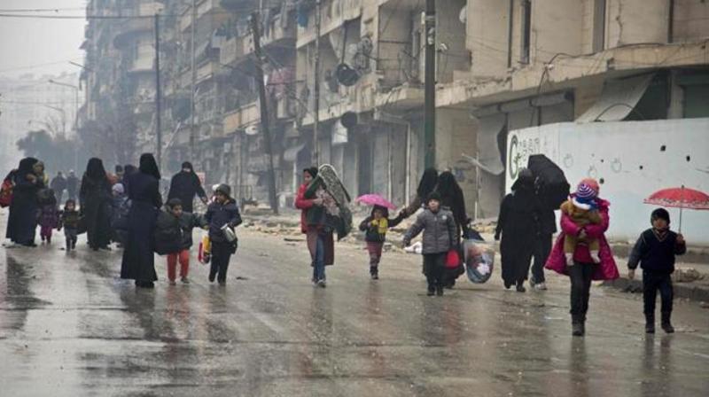 Syrians leave a rebel-held area of Aleppo towards the government-held side on Tuesday during an operation by Syrian government forces to retake the embattled city. (Photo: AFP)