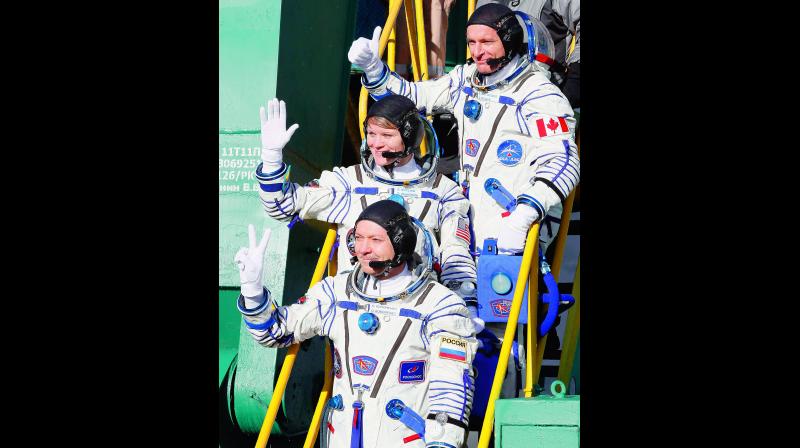 U.S. astronaut Anne McClain, centre, Russian cosmonaut Å¾leg Kononenko, bottom, and CSA astronaut David Saint Jacques during the rocket launch. (Photo: AP)