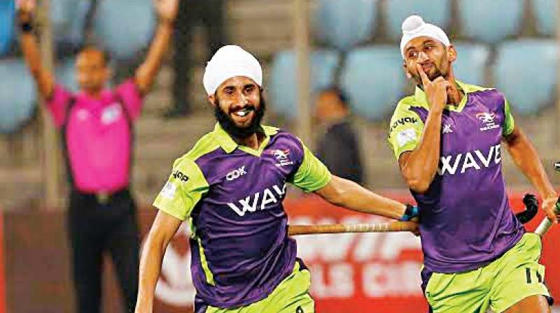 Delhi Waveriders strikers Santa Singh (left) and Mandeep Singh celebrate a goal against Uttar Pradesh Wizards in their HIL-5 match in New Delhi. The hosts won 8-1.