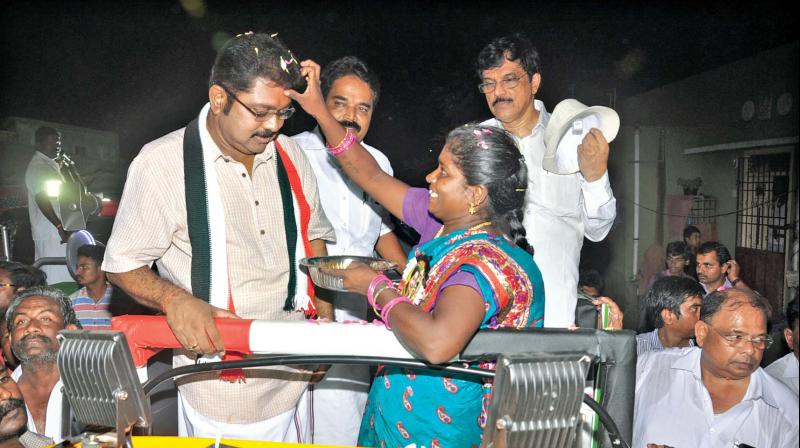 A woman welcomes AIADMK (Amma)s R K Nagar by poll candidate, TTV Dinakaran, with aarathi during his election campaign on Friday. (Photo: DC)