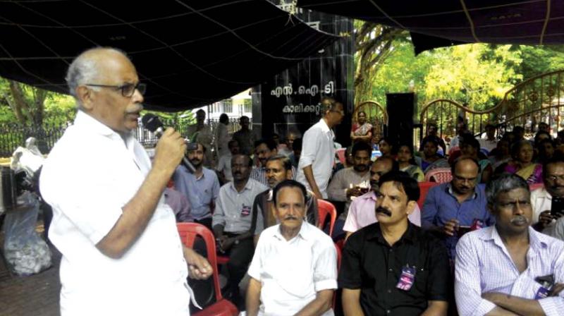 P.T.A. Raheem, MLA, speaks at a dharna in front of NIT-C on Tuesday.