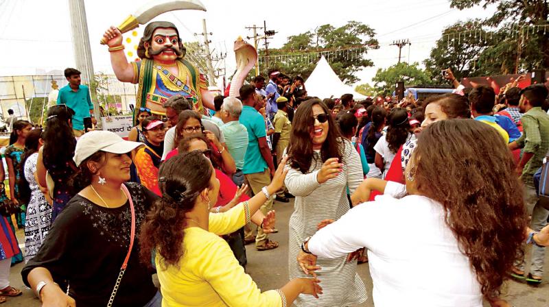 Tourists enjoy Mysuru Dasara Open Street Carnival on Saturday. (Photo: KPN)