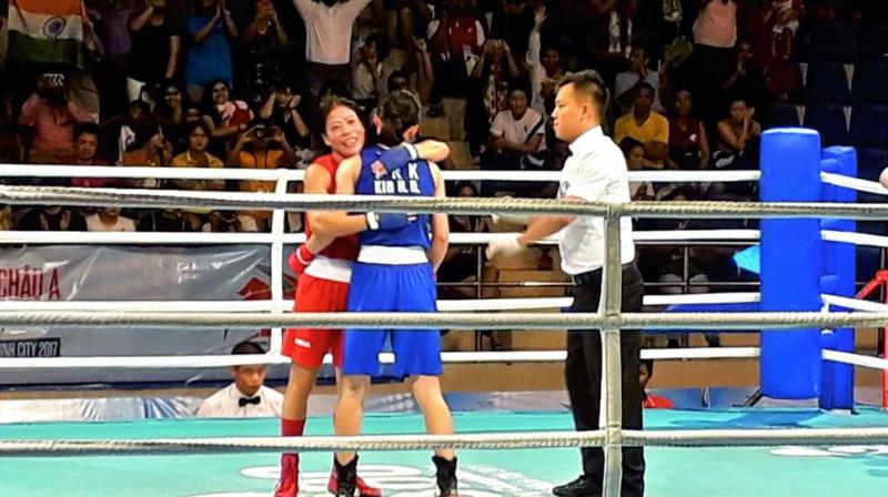 M.C. Mary Kom embraces North Koreas Kim Hyang Mi after the Asian Championships 48kg final in Ho Chi Minh City on Wednesday. Mary won by a 5-0 verdict.