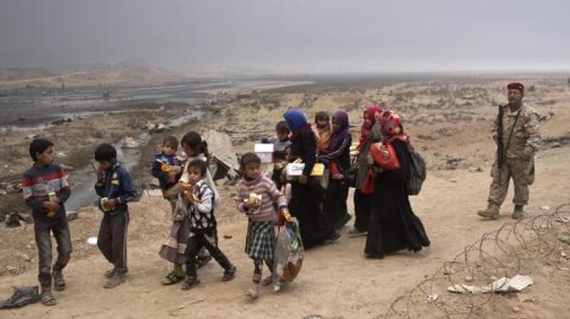 IS militants were going door to door in villages south of Mosul, ordering hundreds of civilians at gunpoint on a forced march north into the city, apparently using them as human shields. (Photo: AP)