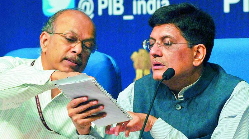 Union minister of state (IC) for power, coal, new & renewable energy & mines Piyush Goyal talks to ministry of power secretary P.K. Pujari (left) while addressing a press conference in New Delhi on Monday (Photo: Pritam Bandyopadhyay)