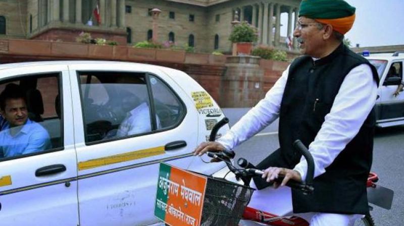 Arjun Ram Meghwal who is minister of state for finance riding a bicycle to Parliament. (Photo: File/PTI)
