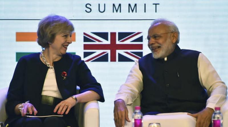 British Prime Minister Theresa May, left, and her Indian counterpart Narendra Modi, attend the India-U.K Tech Summit in New Delhi. (Photo: PTI)