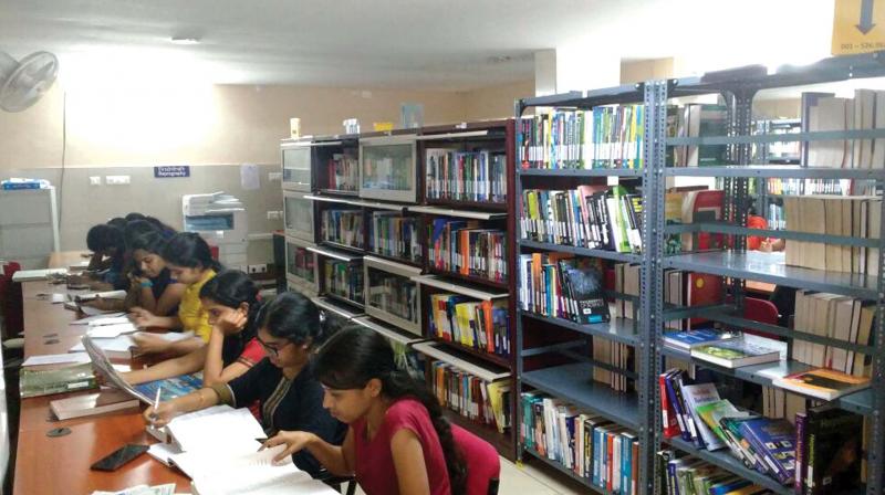 Girl students of Central University of Kerala spend night inside the university library building on Tuesday. (Photo: DC)
