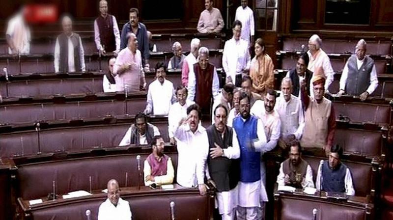 Opposition members protest in the well of the Rajya Sabha during the winter session of Parliament in New Delhi. (Photo: PTI)