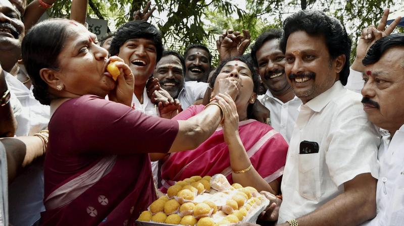 AIADMK senior leaders P Valarmathi and Gokula Indira celebrating their partys victory in Assembly bypolls in front of Apollo Hospital where Chief Minister J Jayalalithaa is undergoing treatment, in Chennai. (Photo: PTI)