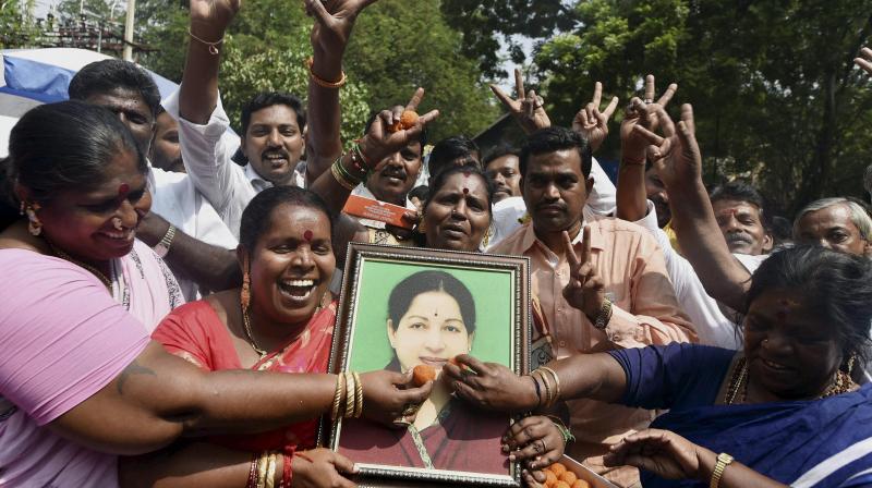 AIADMK cadres celebrating for their partys victory of Assembly bypolls in front of Apollo Hospital where Chief Minister J Jayalalithaa is undergoing treatment, in Chennai. (Photo: PTI)