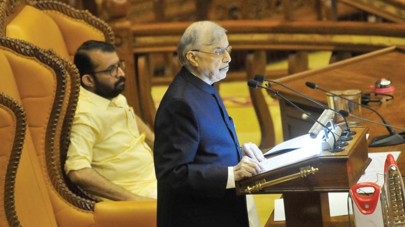 Governor P. Sathasivam addresses the Assembly as Speaker P. Sreeramakrishnan looks on Friday.  (A.V. MUZAFAR)