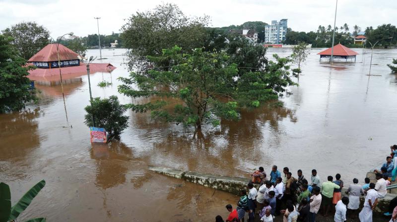 The Siva Temple in Aluva is fully sub-merged on Thursday as water level in River Periyar went following the opening of the shutters of Idmalayar Dam. A large number of people gathered to witness the swelling river waters in the area. (ARUN CHANDRABOSE)