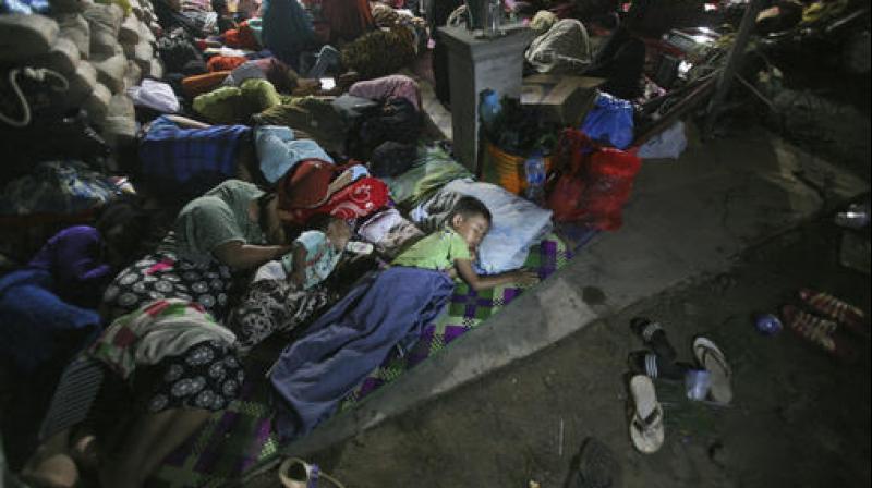 Earthquake survivors sleep on the ground at a temporary shelter in Ulim, Aceh province, Indonesia. (Photo: AP)