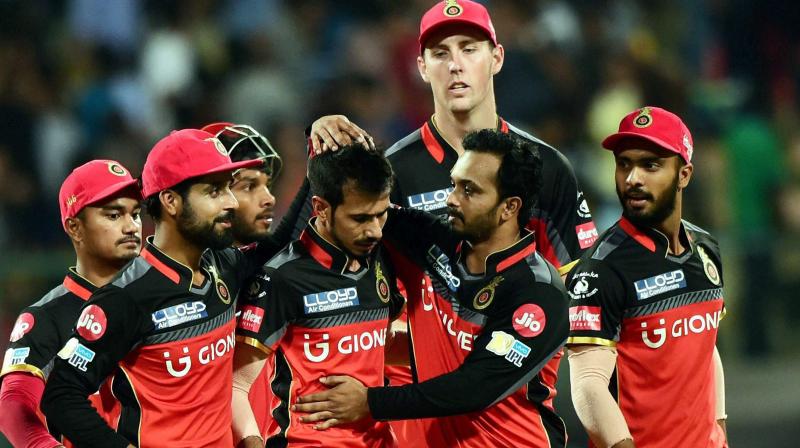 Royal Challengers Bangalore Yuzvendra Chahal with team mates celebrate the wicket of Carlos Brathwaite during the IPL 10 match against Delhi Daredevils at Chinnaswamy stadium in Bengaluru on Saturday. (Photo: AP)