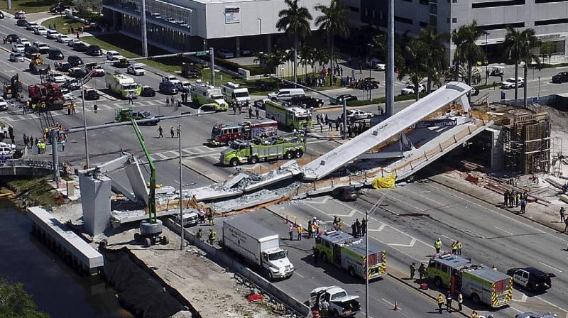 Emergency personnel respond after a brand-new pedestrian bridge collapsed onto a highway at Florida International University in Miami on Thursday, March 15, 2018. (Photo: AP)