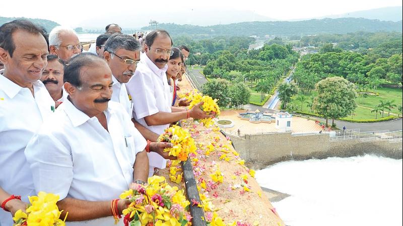 Electricity minister P. Thangamani (third from left), higher education minister K. P. Anbhazhagan and environment minister K. C. Karupannan at the opening of water from Mettur dam near Salem on Monday. (Photo: DC)