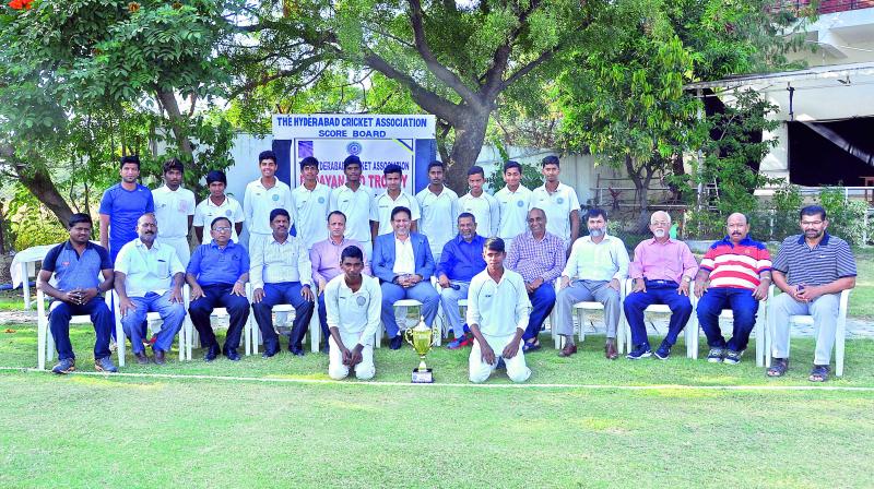 The Chaitanya Junior Kalasa team pose with officials of the Hyderabad Cricket Association at the Gymkhana ground after winning the Under 16 cricket tournament for the R. Dayanand Trophy.