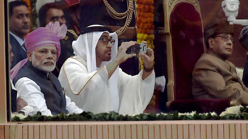 President Pranab Mukherjee, Prime Minister Narendra Modi look on as General Sheikh Mohammed Bin Zayed Al Nahyan, Crown Prince of Adu Dhabi take photo from his mobile during the 68th Republic Day celebrations at Rajpath in New Delhi. (Photo: PTI)