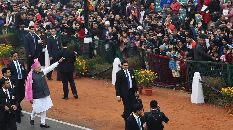 Prime Minister Narendra Modi waves to the crowed as he leaves after attending the 68th Republic Day celebrations at Rajpath in New Delhi. (Photo: PTI)