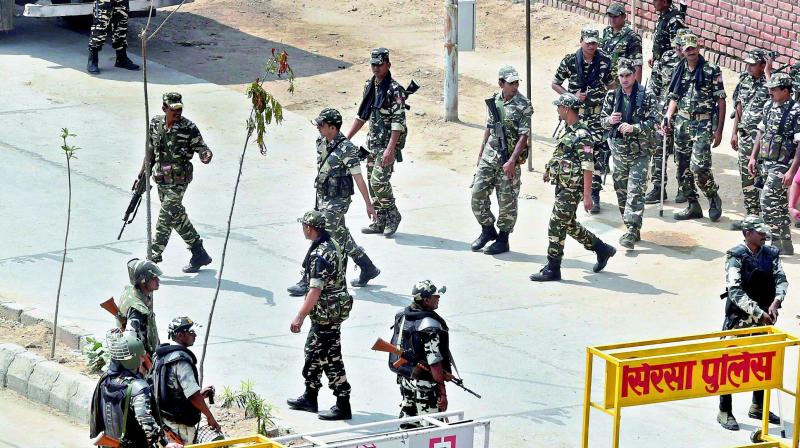 Securitymen personnel deployed at Kirti Nagar near Dera Sacha Sauda in Sirsa on Monday, ahead of the  the pronouncement of quantum of sentence in Dera chief Gurmeet Ram Rahim Singhs case. 	(Photo: PTI)