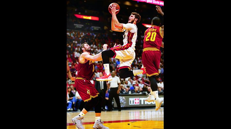 Miami Heats Tyler Johnson goes up for a shot against Cleveland Cavaliers Kevin Love during their game on Monday. Miami Heat beat Cleveland Cavaliers 124-121. (Photo: AP)