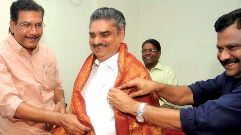 A. Sampath, MP, and I.B. Satheesh, MLA, drape a shawl over Jayan Babu who took charge as TRIDA chairman on Thursday.(Photo: A.V. MUZAFAR)