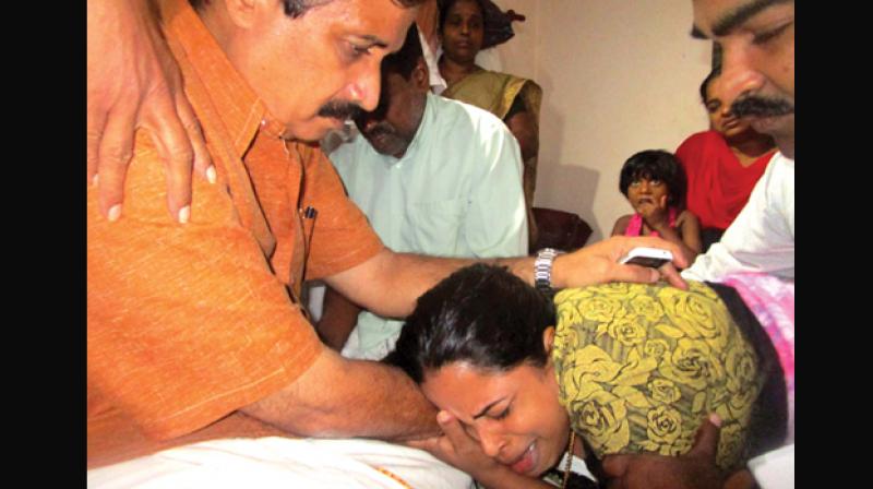 Education minister C. Raveendranath consoles Jishnu Pranoys parents. The minister visited Jishnus house in Nadapuram in Kozhikode on Thursday. (Photo: DC)