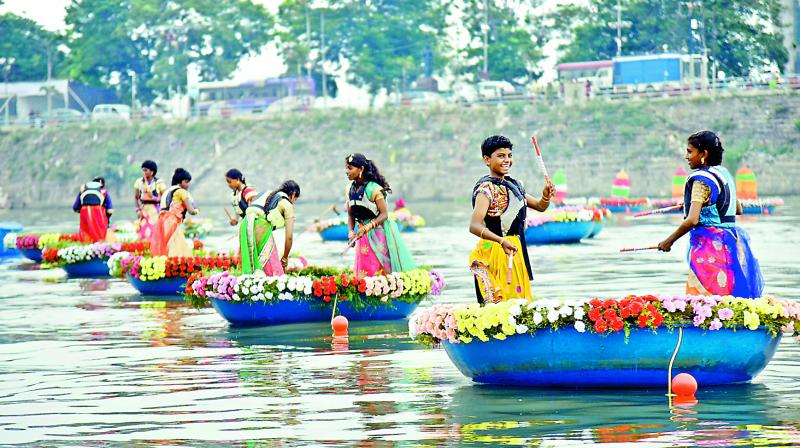Young sailors from the Yatch club on Monday celebrate Bathukamma on coracles in Hussainsagar organised by the tourism department. A coracle race was also held. (Photo: Gandhi)