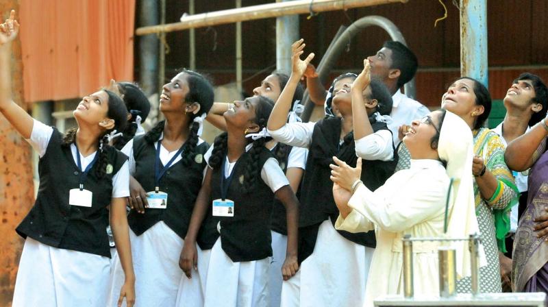 Students watch as their paper rockets fly up during the  workshop. (Photo: DC)